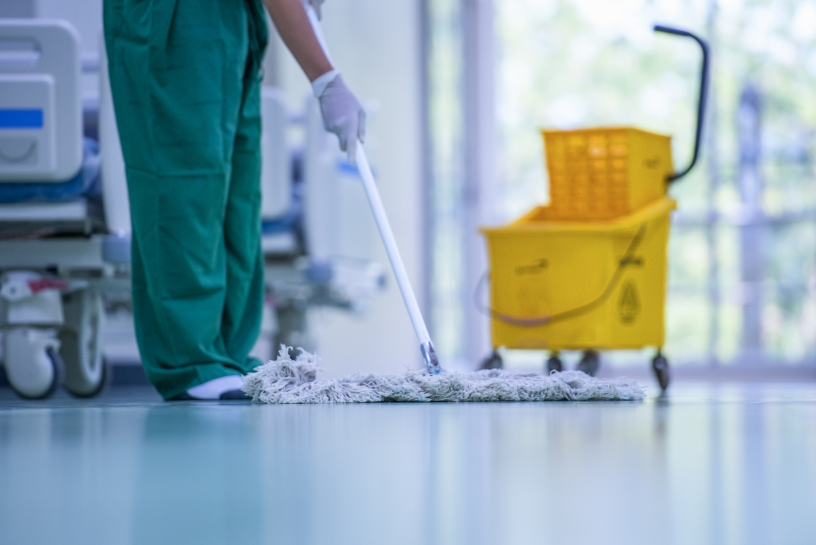 Floor care and cleaning services with washing mop in sterile factory or clean hospital.